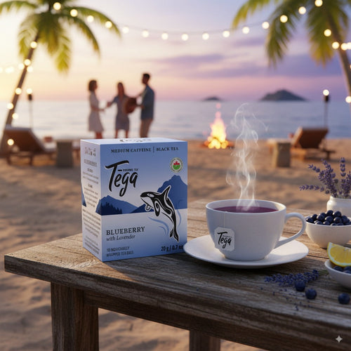 Blueberry Lavender Organic fgdffg tea bags on a beach with a steaming cup of tea and friends in the background.